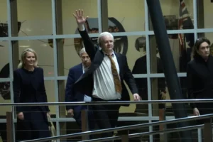 Julian Assange acena após chegar à Austrália